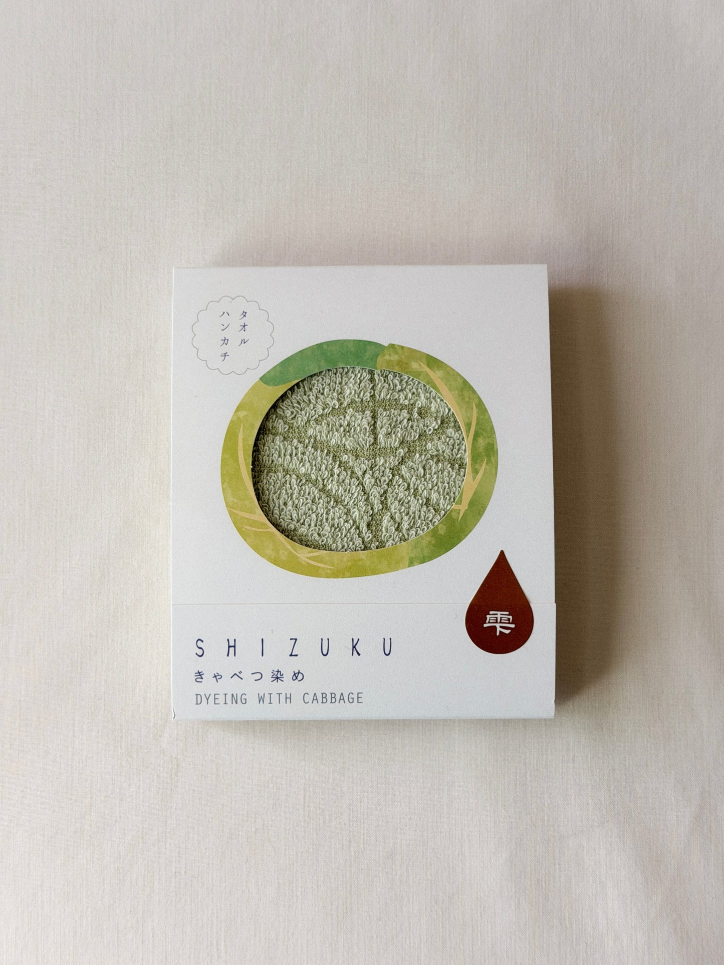 Packaged green towel with a cut-out of a cabbage