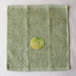 Light green towel with a cabbage illustration in the center on a white background