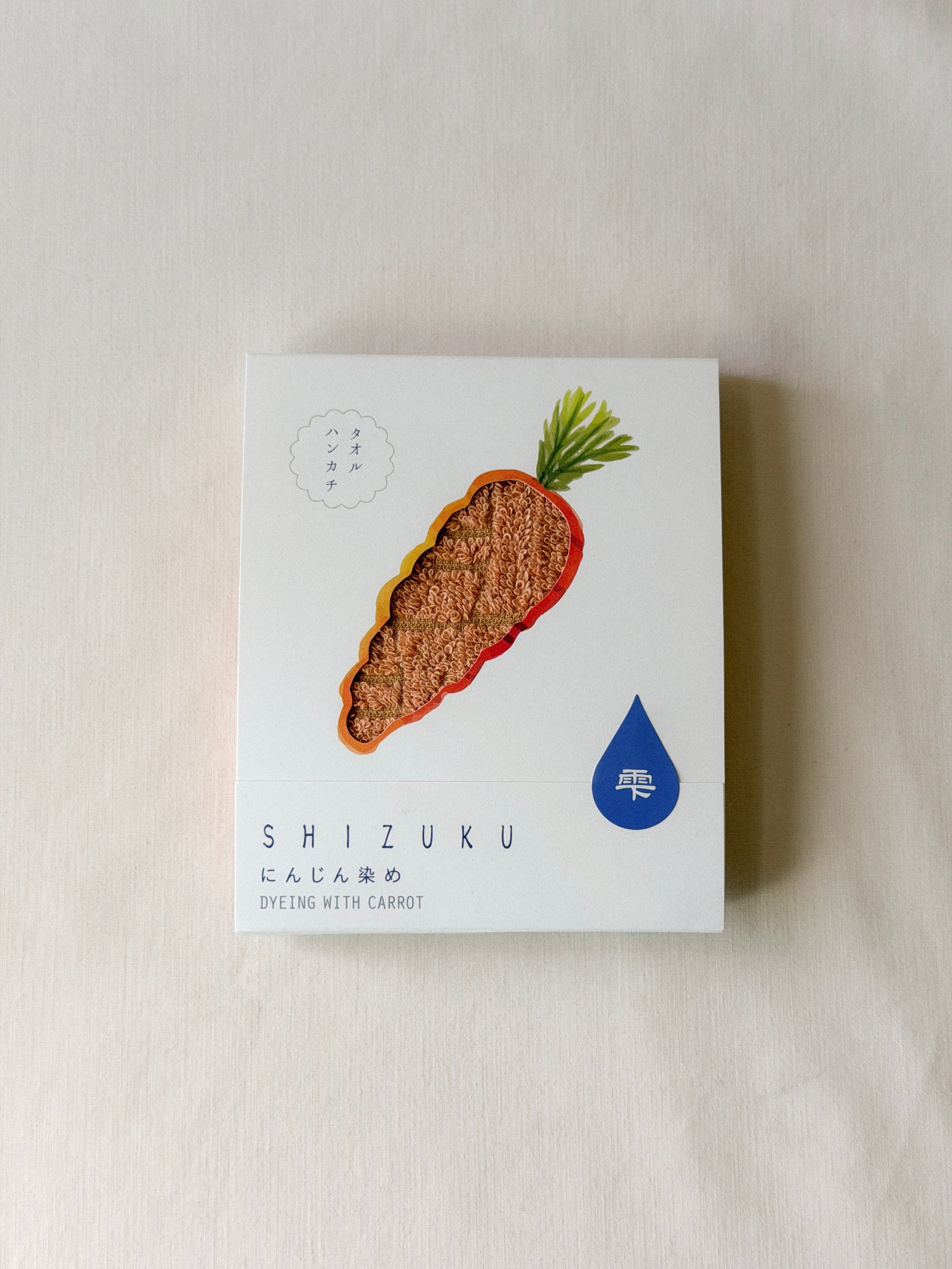 Packaged orange towel with a cut-out of a carrot