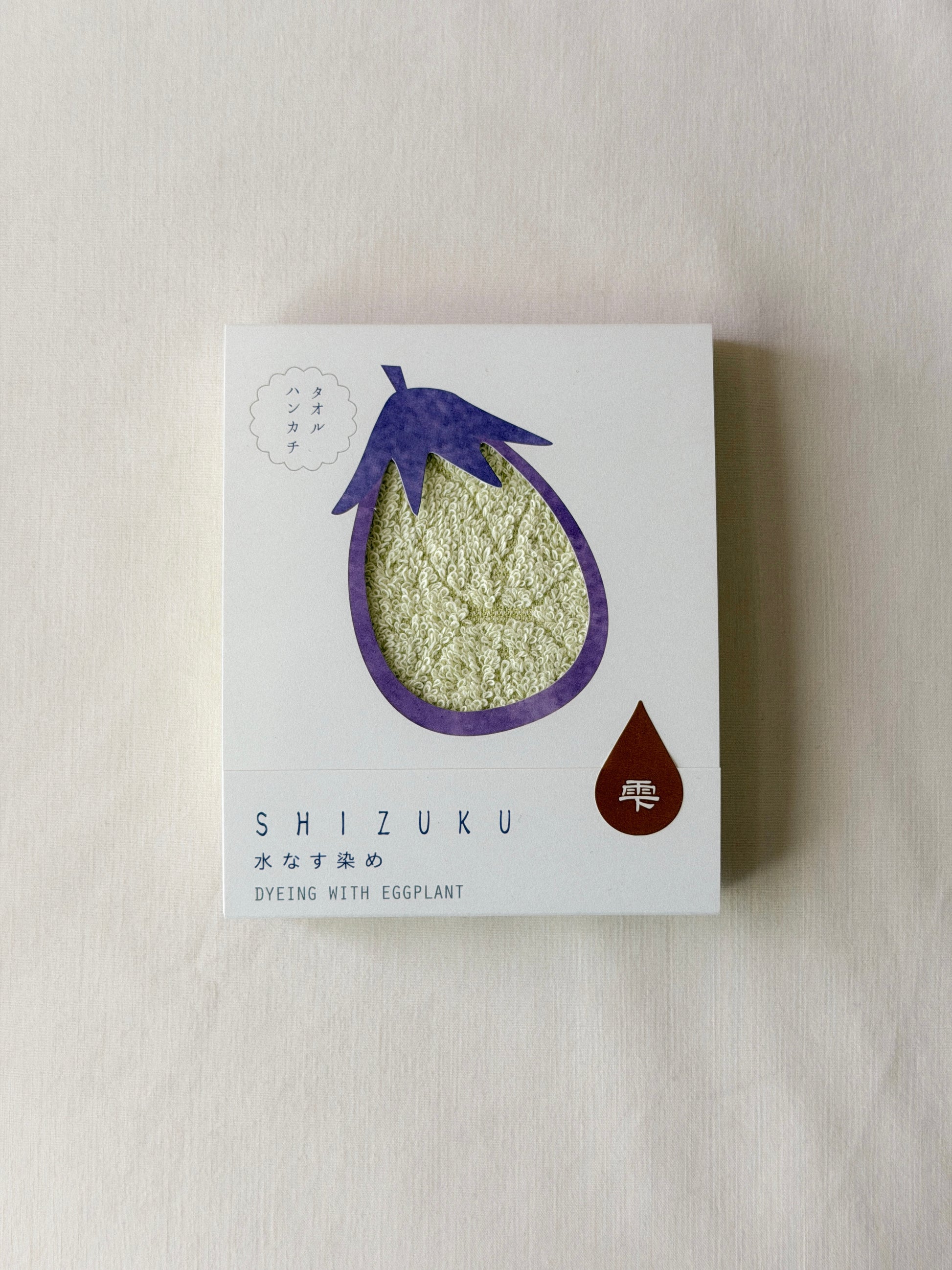 Packaged light green towel with a cut-out of an onion