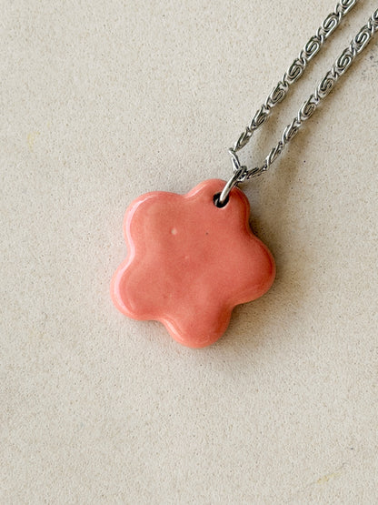 Stainless steel necklace with a glossy floral shaped pink ceramic pendant