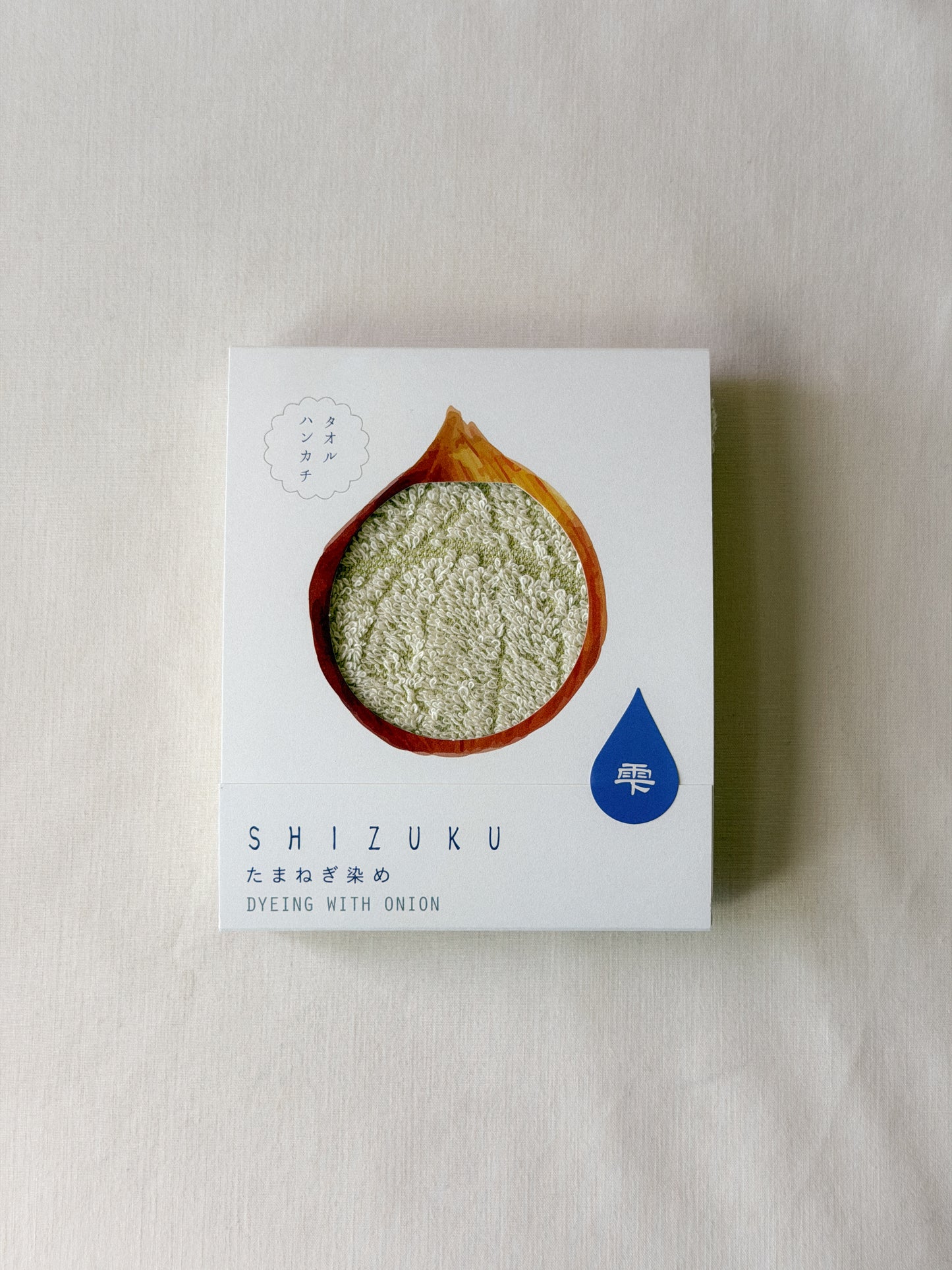 Packaged light beige towel with a cut-out of an onion